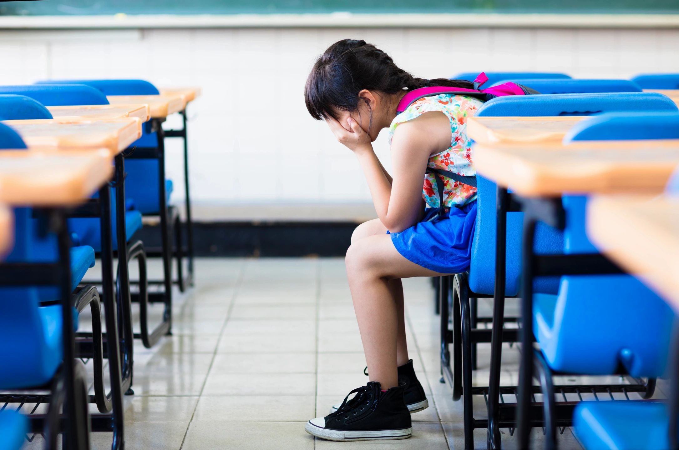 Student struggling at desk